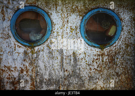 Color shot of two portholes on an old ship. Stock Photo