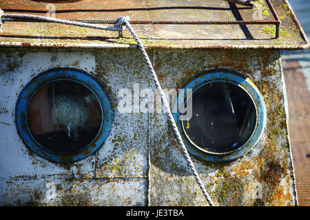 Color shot of two portholes on an old ship. Stock Photo