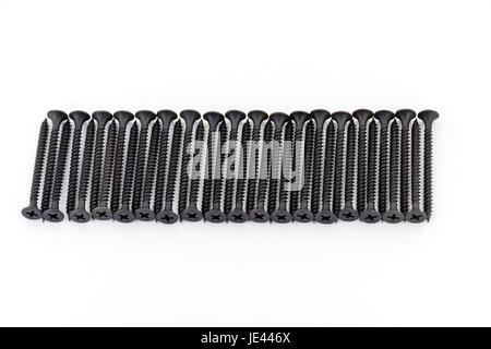 A raw of avarage black Oxidized self-tapping screws isolated on white background Stock Photo