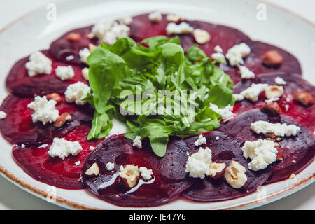 Fresh green salad with beets, goat cheese and olive oil, healthy food, organic. Stock Photo