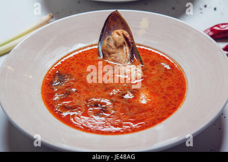 Tomato soup with seafood with shrimps and oysters. Stock Photo