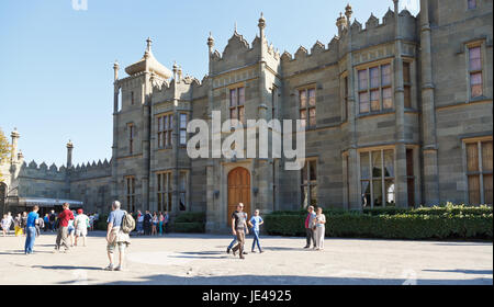 ALUPKA, RUSSIA - SEPTEMBER 28, 2014: tourists near northern entrance facade of Vorontsov (Alupka) Palace in Crimea. The palace was built between 1828 and 1848 for Prince Vorontsov. Stock Photo