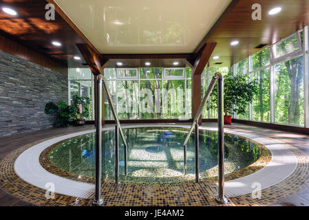 Big luxury jacuzzi thub in hotel spa green area Stock Photo