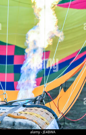 Fire heats the air inside a hot air balloon at balloon festival Stock Photo