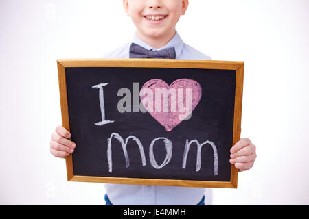 Small blackboard with love declaration held by a boy Stock Photo