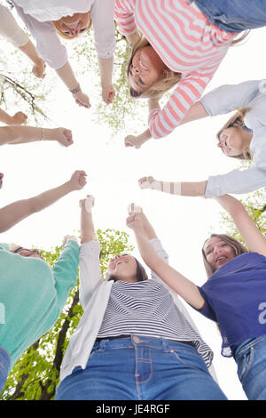 Happy smiling group of young friends staying together outdoor in the park Stock Photo