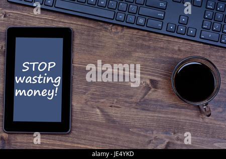 Text Stop wasting money on digital tablet pc Stock Photo