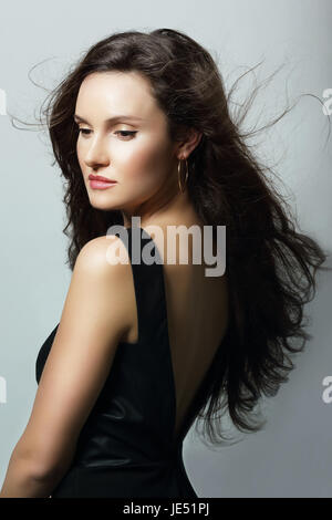 Charm. Aristocratic Lady in Black Dress and Flowing Hair Stock Photo