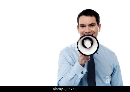 Happy man making announcement over a megaphone Stock Photo