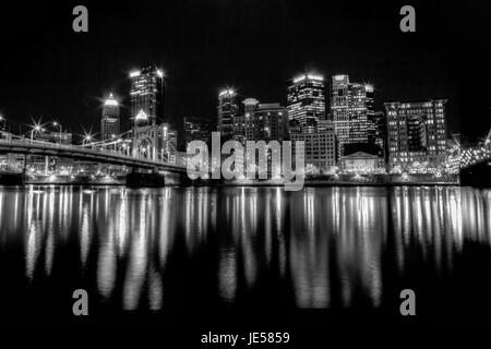 Black and white photo of the Pittsburgh, Pennsylvania skyline at night overlooking the Allegheny River with the Andy Warhol Bridge. Stock Photo