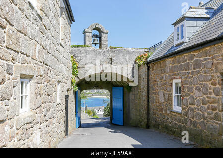 A bell tower over a stone archway and blue doors on Garrison Hill, Hugh Town, St. Mary's, Isles of Scilly, England, UK Stock Photo