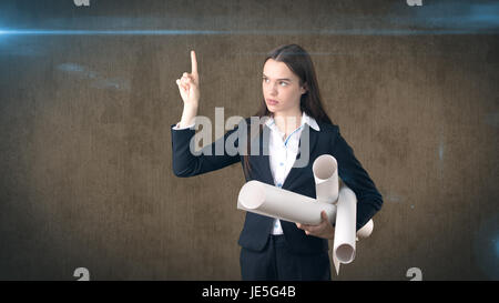 Building, developing, consrtuction and architecture concept -professional beautiful businesswoman in suit with blueprint Stock Photo