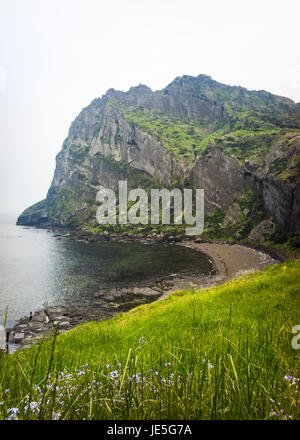 Seongsand Ilchulbong is also known as Sunrise Peak and is a Unesco world heritage site. It is situated on the eastern side of the island jutting out f Stock Photo