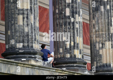 16th of June 2017 in Berlin, Germany: A tourist is having a rest in front of the 'Altes Museum' in Berlin, Germany Stock Photo