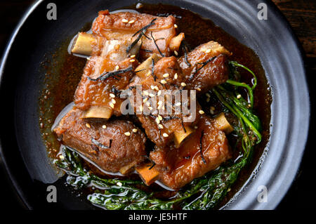 Chinese sweet steamed pork  setting on black japanese style plate in studio lighting. Stock Photo