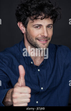 Man giving thumbs up and smiling, portrait Stock Photo