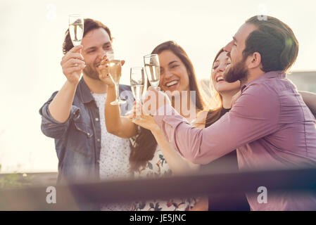 Friends drinking champagne together outdoors Stock Photo