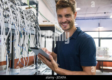 Electrical engineer smiling cheerfully, portrait Stock Photo