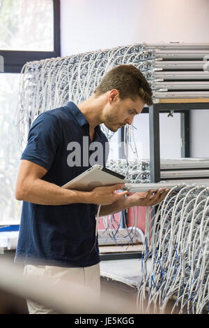 Man inspecting products in factory Stock Photo