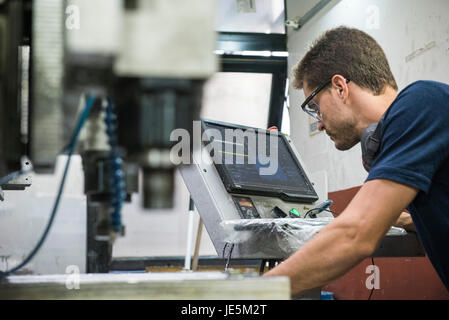 Machinist working in factory Stock Photo