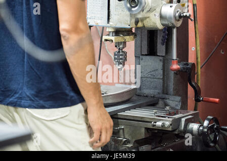 Factory worker using drill Stock Photo