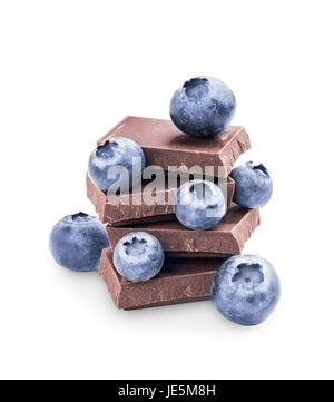 Stack of dark chocolate and fresh ripe blueberries. Blueberry and chocolate isolated on white background with clipping path. Stock Photo