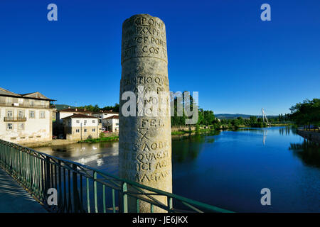 A pillar with roman inscriptions on the roman bridge of Chaves, also known as Trajan bridge, dating back to the 1st century AD. Portugal Stock Photo