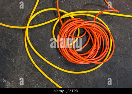 Electrical color cables lay in rolls over black ground Stock Photo