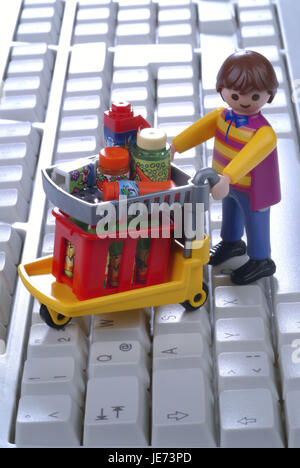 Character by shopping cart on computer keyboard, Stock Photo