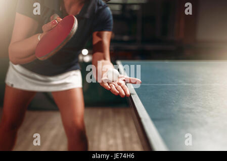 Table tennis, female player with racket and ball. Ping pong training indoor, high concentration sport game Stock Photo