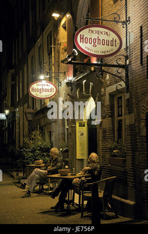 Holland, the Netherlands, Amsterdam, Two men sit before a restaurant, Stock Photo