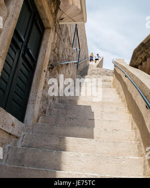 Tourists ascending the great city walls of Dubrovnik on the Dalmatian Coast of Croatia Stock Photo