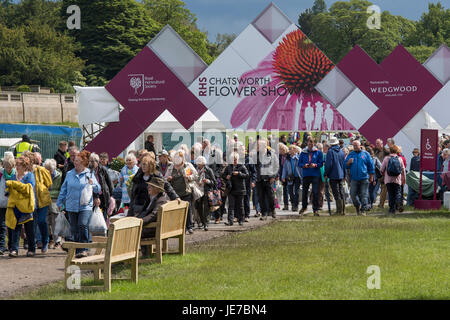 Home time - a large crowd of people are walking out of the exit to the first RHS Chatsworth Flower Show, Chatsworth House, Derbyshire, England, UK. Stock Photo