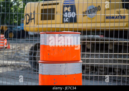 Montreal, Canada - June 18, 2017: Traffic cone on construction road in front of the fence on Sherbrooke street. Stock Photo