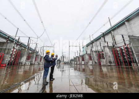 Jinhua, China's Zhejiang Province. 23rd June, 2017. Staff members inspect the convertor station in Jinhua, east China's Zhejiang Province, June 23, 2017. The Sichuan Xiluodu-Zhejiang Jinhua 800 KV ultra-high voltage (UHV) direct current (DC) power transmission project, one of the world's largest DC power transmission projects in terms of capacity, has transmitted over 100 billion kwh clean hydropower into Zhejiang by now. Credit: Xu Yu/Xinhua/Alamy Live News Stock Photo