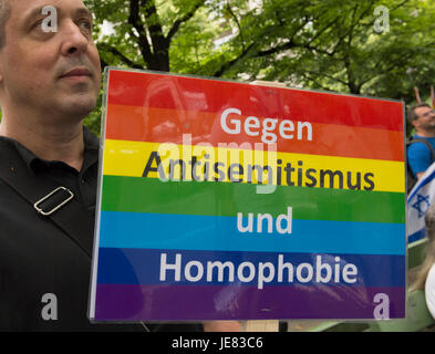 Berlin, Germany. 23rd June, 2017. A pro-Israel protestor holds a placard with the slogan 'Against Antisemitism and Homophobia' at a demonstration against Al-Quds Day in Berlin, Germany, 23 June 2017. Al-Quds Day, which takes its name from the Arabic name of Jerusalem, is an Iranian-sponsored show of solidarity with Palestinians and against Israel. The day is a national holiday in Iran. Demonstrations are held in the US, Canada, the UK, Sweden and Germany as well as the Middle East. Photo: Paul Zinken/dpa/Alamy Live News Stock Photo