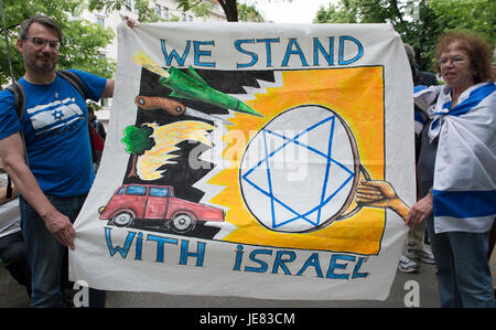 Berlin, Germany. 23rd June, 2017. The former culture secretary of Berlin, Tim Renner (L), holds a banner with the slogan 'We Stand with Israel' during a demonstration against Al-Quds Day in Berlin, Germany, 23 June 2017. Al-Quds Day, which takes its name from the Arabic name of Jerusalem, is an Iranian-sponsored show of solidarity with Palestinians and against Israel. The day is a national holiday in Iran. Demonstrations are held in the US, Canada, the UK, Sweden and Germany as well as the Middle East. Photo: Paul Zinken/dpa/Alamy Live News Stock Photo