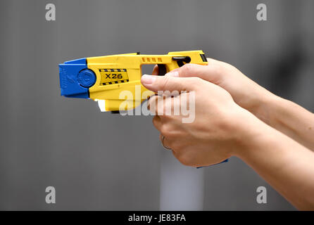 Taser, police officer using a taser during training. The focus of the event is to demonstrate the transparency around Dorset Police's use of force and the challenges involved, along with an overview of equipment and the skills that improve public and officer safety.  This comes ahead of the publication of use of force data by individual police forces nationally at the end of July. An officer demonstrates using an X26 Taser Credit: Finnbarr Webster/Alamy Live News Stock Photo