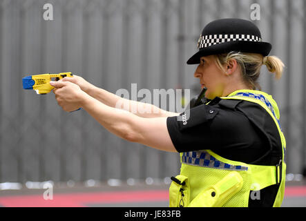 Taser, police officer using a taser during training. The focus of the event is to demonstrate the transparency around Dorset Police's use of force and the challenges involved, along with an overview of equipment and the skills that improve public and officer safety.  This comes ahead of the publication of use of force data by individual police forces nationally at the end of July. An officer demonstrates using an X26 Taser Credit: Finnbarr Webster/Alamy Live News Stock Photo