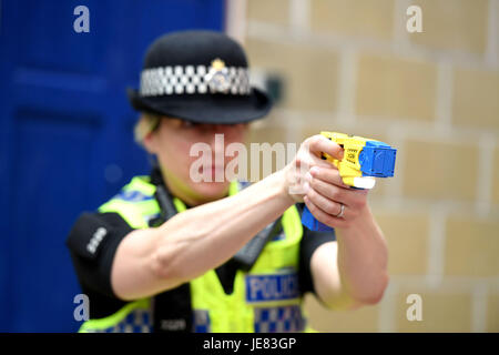 Taser, police officer using a taser during training. The focus of the event is to demonstrate the transparency around Dorset Police's use of force and the challenges involved, along with an overview of equipment and the skills that improve public and officer safety.  This comes ahead of the publication of use of force data by individual police forces nationally at the end of July. An officer demonstrates using an X26 Taser Credit: Finnbarr Webster/Alamy Live News Stock Photo