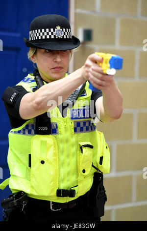 Taser, police officer using a taser during training. The focus of the event is to demonstrate the transparency around Dorset Police's use of force and the challenges involved, along with an overview of equipment and the skills that improve public and officer safety.  This comes ahead of the publication of use of force data by individual police forces nationally at the end of July. An officer demonstrates using an X26 Taser Credit: Finnbarr Webster/Alamy Live News Stock Photo