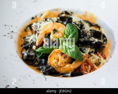 Black fettuccine with seafood Stock Photo