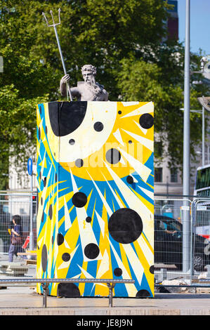 Neptune peering out of his gaily painted protective box in Bristol city centre during extensive roadworks to install a Metrobus system - Bristol UK Stock Photo