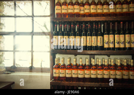 https://l450v.alamy.com/450v/je90a6/light-rays-in-a-small-wine-cellar-with-a-hand-made-wine-bottles-arranged-je90a6.jpg