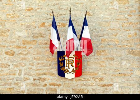French flag and coat of arms on stone building in Ventouse France Stock Photo