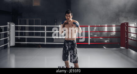 Young man boxing workout on the ring Stock Photo