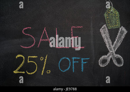 Sale 25% off. Sale and discount price sign with scissors cutting price tag drawn with chalk on blackboard Stock Photo