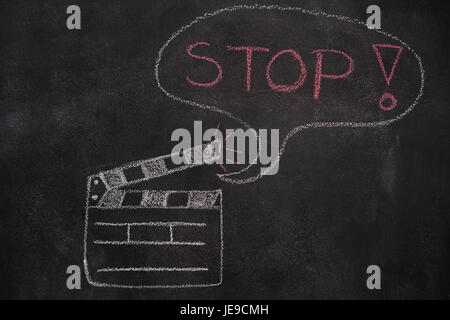 Open movie clapper and speech bubble with stop word drawn with chalk on blackboard Stock Photo