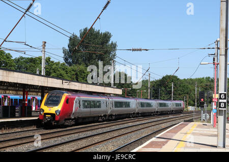 Virgin West Coast liveried super voyager class 221 diesel multiple unit train leaving Lancaster railway station platform 3 on the West Coast Main Line Stock Photo