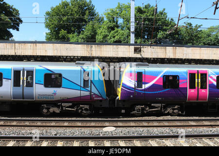 Old and new First TransPennine express liveries on two class 350 electric multiple units in Lancaster railway station on the West Coast Main Line. Stock Photo